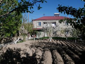 a house with a red roof and trees at Karin's B&B in Sisian