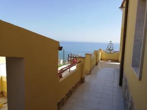 a balcony of a building with a view of the ocean at Villa Fiorella in Sciacca