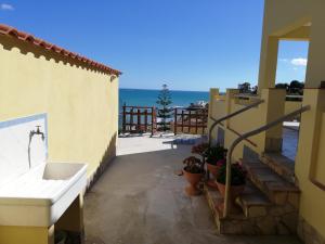 a view of the ocean from the balcony of a house at Villa Fiorella in Sciacca