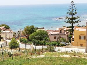 a view of the ocean from a town with a fence at Villa Fiorella in Sciacca