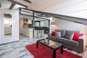 a living room with a couch and a red rug at Luna Apartment in Madrid