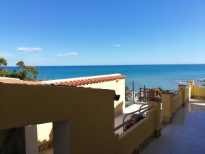 a view of the ocean from the balcony of a building at Villa Fiorella in Sciacca