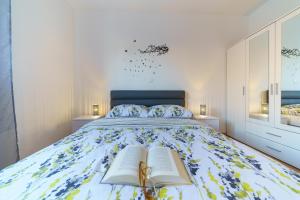 a bedroom with a bed with two books on it at Holiday house Roko in Gornji Zemunik +9 photos