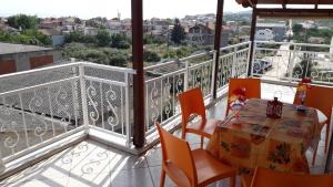a balcony with a table and chairs and a view at HOUSE DILENA TSIMTSIRI in Limenaria
