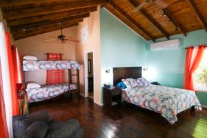 a bedroom with two beds and a couch at Casita Océana in Sandy Bay