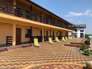 a row of yellow chairs sitting on a patio at Panorama in Vapnyarka