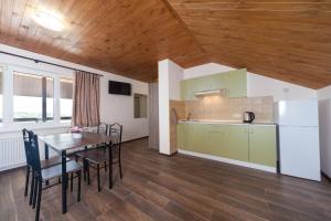 a kitchen and dining room with a table and chairs at Panorama in Vapnyarka
