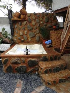 a bathroom with a sink made out of a rock wall at Hostal Rutamar in Canoa