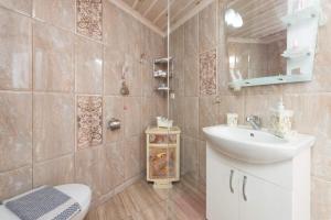 a bathroom with a sink and a toilet and a mirror at Mario's house in Kallirakhi