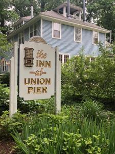 a sign for the inn at union pier in front of a house at The Inn at Union Pier in Union Pier