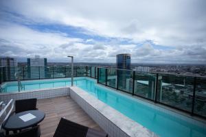 a swimming pool on the roof of a building at Flat Boa Viagem in Recife