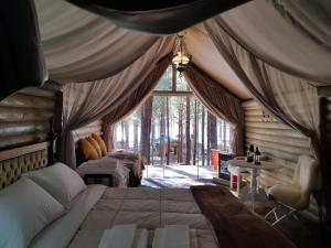 a bedroom with two beds and a large window at Tedesco Eco Park in São Francisco de Paula