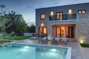 a house with a swimming pool in front of it at Villa Lobe in Pula