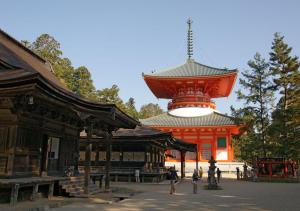 an orange building with a red tower on top of it at Hostel Inn Hashimoto in Hashimoto