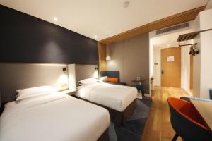 Postel nebo postele na pokoji v ubytování Holiday Inn Express Hefei Shushan by IHG