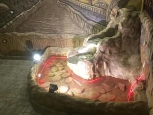 a room with a rock fireplace in a cave at Al-Madina Tower Apartments in Marsa Matruh