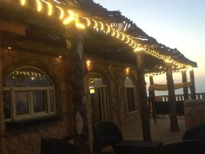 a stone building with lights on a patio at Al-Madina Tower Apartments in Marsa Matruh