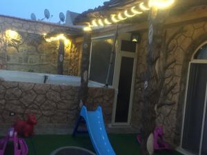 a house with a play yard and a playground at Al-Madina Tower Apartments in Marsa Matruh