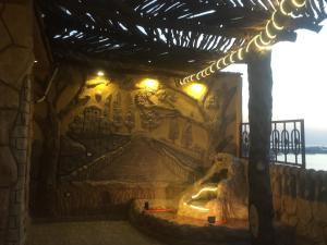 a room with a wall with a painting on it at Al-Madina Tower Apartments in Marsa Matruh