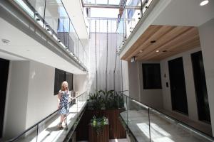 a woman walking down a staircase in a building at Carmel at Sorrento in Sorrento