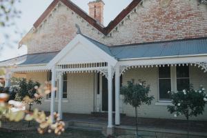 a house with a porch with a blue roof at Dubuque Bed and Breakfast in Numurkah