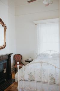 a bedroom with a white bed and a window at Dubuque Bed and Breakfast in Numurkah