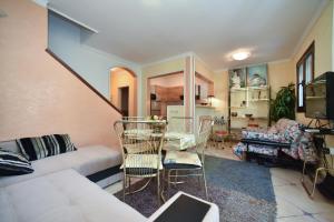 a living room with a couch and a table and chairs at Bologna Apartments in Budva