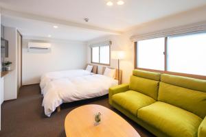 a living room with a couch and a bed at SO Kyoto Fushimi Inari in Kyoto