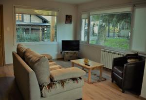 a living room with a couch and a table at Andalue in San Carlos de Bariloche