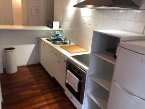a small kitchen with a sink and a stove at Boulevard GRAZIANI in Bastia