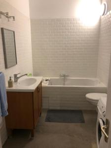 a bathroom with a sink and a tub and a toilet at Boulevard GRAZIANI in Bastia