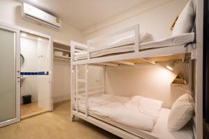 a bedroom with two bunk beds in a room at MORN-ING HOSTEL in Lat Krabang