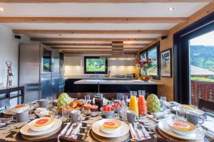 a dining room with a table with food on it at Chalet Melchior in Villars-sur-Ollon