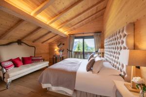 a bedroom with a large bed and a window at Chalet Melchior in Villars-sur-Ollon