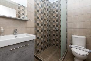 a bathroom with a toilet and a sink at Ioanna Studios in Skala Kallirachis