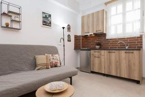 a living room with a couch and a kitchen at Ioanna Studios in Skala Kallirachis +22 photos