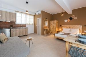 a bedroom with a bed and a kitchen and a room with at Ioanna Studios in Skala Kallirachis