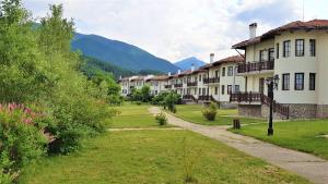 a row of houses with mountains in the background at Pinerose Resort in Bansko