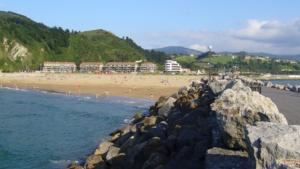 a beach with a bunch of people on the sand at ORIO PLAYA in Orio