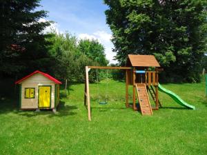 a playground with a slide and a play house at Penzion Hejtman in Chlum u Třeboně
