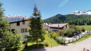 an aerial view of a house with mountains in the background at Apartment Panorama in Celerina