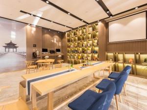 a dining room with a table and chairs at Atour Hotel Suzhou Industrial Park Qingjian Lake Branch in Suzhou