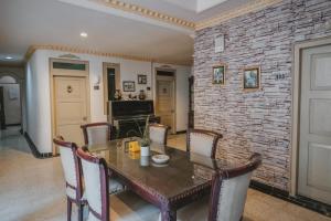 a dining room with a table and a brick wall at RedDoorz Plus @ Tanjung Karang Lampung 2 in Bandar Lampung