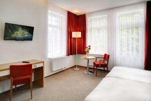 מיטה או מיטות בחדר ב-Hotel Astoria