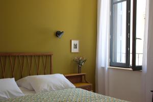 a bedroom with a bed and a window at midi03 in Carcassonne