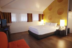 Ліжко або ліжка в номері Hotel Internazionale Bellinzona