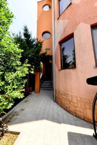 a building with a stairway leading to a door at Vila Eden in Eforie Nord