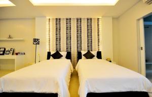 Giường trong phòng chung tại Surintra Boutique Resort