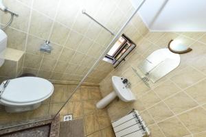 a bathroom with a toilet and a sink at Vila Eden in Eforie Nord +37 photos