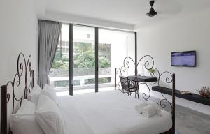 Un ou plusieurs lits dans un hébergement de l'établissement Surintra Boutique Resort